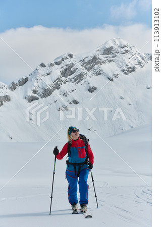 A Female Mountaineer Ascends the Alps with Backcountry Gear A Female Mountaineer Ascends the Alps with Backcountry Gear 113913102