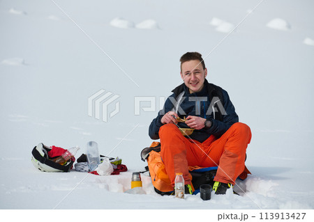 A Skier Takes a Well-Deserved Break to Enjoy the View A Skier Takes a Well-Deserved Break to Enjoy the View 113913427