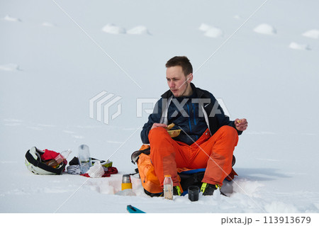 A Skier Takes a Well-Deserved Break to Enjoy the View 113913679