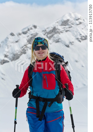 A Female Mountaineer Ascends the Alps with Backcountry Gear 113913780
