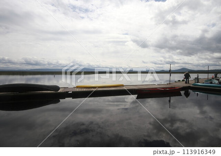 Boats in a marina on a lake 113916349
