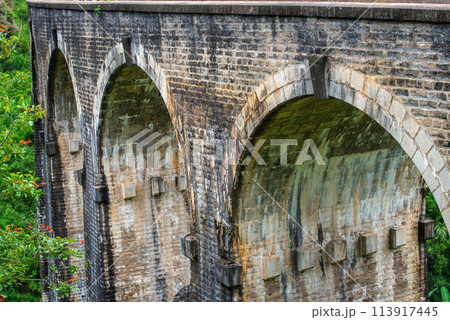 View of Nine Arch Bridge a very picturesque spot in Ella, Sri Lanka. Ella is a mountain town in the Central Highland of Sri Lanka surrounded by the beautiful greens of tea plantation field. View of Nine Arch Bridge a very picturesque spot in Ella, Sri Lanka. Ella is a mountain town in the Central Highland of Sri Lanka surrounded by the beautiful greens of tea plantation field. 113917445