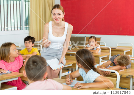 Children listening carefully to teacher 113917846