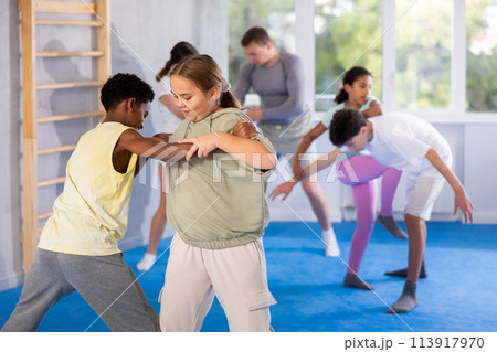 Boy and girl practicing self-defense techniques 113917970