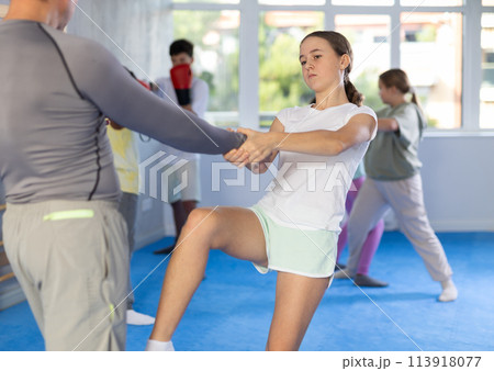 Teenage girl kicking instructor in groin during...の写真素材 [113918077] - PIXTA