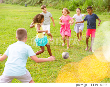 Cheerful tween friends playing with ball outdoors in summer 113918086