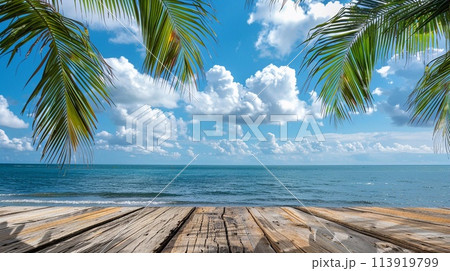 Wooden table for product presentation with sea view with palm leaves and blue sky. 113919799