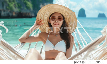 Summer travel concept, Happy traveler young woman with bikini relax in hammock on beach. 113920505