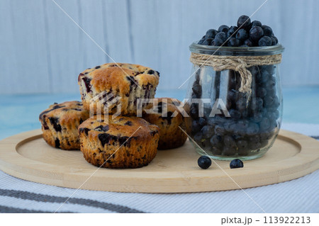 Homemade baked blueberry muffins with fresh harvested blackberries in glass jar. Tasty pastry sweet cupcake dessert. Berry pie cupcakes with organic berries. Gluten free healthcare recipe from 113922213