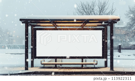 Blank billboard on bus stop during snowfall. Mockup for advertising banners or design. 113922311