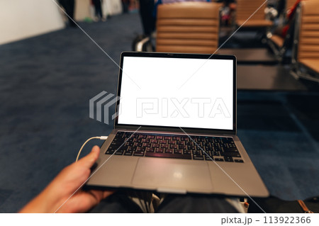 A laptop with blank screen on chair at airport 113922366