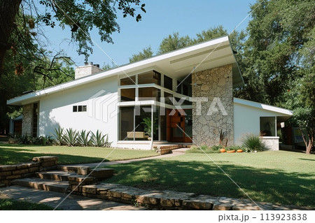 Modern house with gable roof and stone front garden, the essence of a classic yet simple architectural style. 113923838