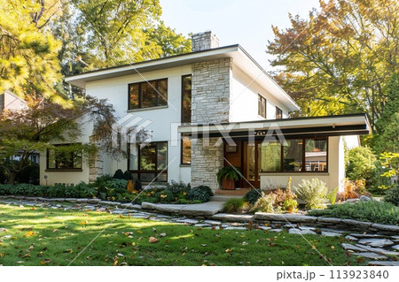 Modern house with gable roof and stone front garden, the essence of a classic yet simple architectural style. 113923840