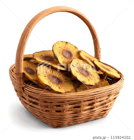 Dried plantain slices in a rustic wicker basket light brown with a starchy texture 113924102