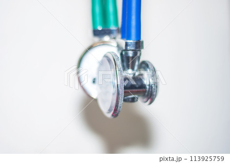 Close up of stethoscope with green and blue handles Close up of stethoscope with green and blue handles 113925759
