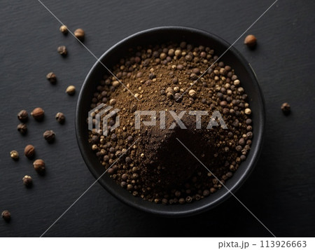 Black pepper powder on a black background. 113926663