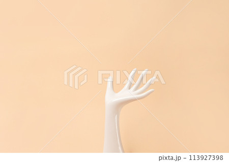 White ceramic statue hand on beige background with copy space White ceramic statue hand on beige background with copy space 113927398