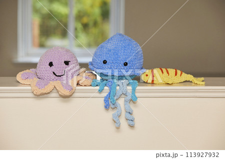 Cute knitted toy octopus, jellyfish and fish at home 113927932