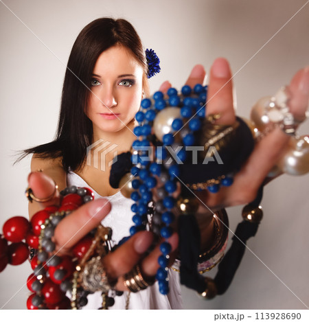 summer girl with plenty of jewellery, beads in hands 113928690