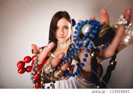 summer girl with plenty of jewellery, beads in hands 113928691