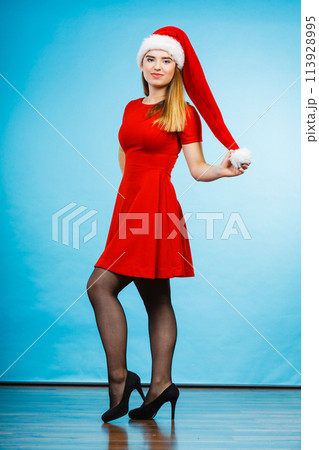 Woman wearing Santa Claus helper costume dress 113928995