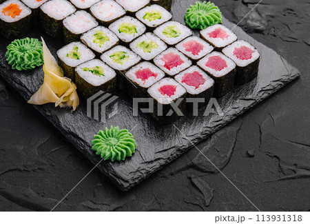 Maki sushi set served on black stone tray 113931318