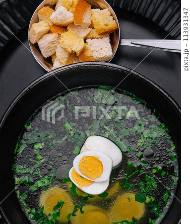 Homemade bouillon or broth with egg 113931347