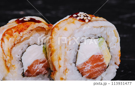 canada roll with salmon on black stone 113931477