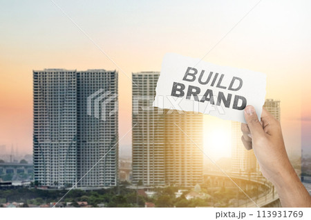 Human hand showing ripped paper with build brand text Human hand showing ripped paper with build brand text 113931769