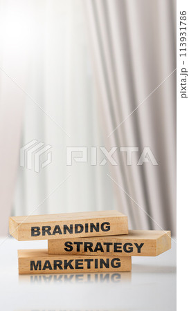 Stack of small wooden blocks with branding strategy marketing text 113931786