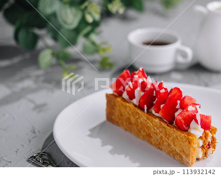 Piece of Napoleon Cake with Strawberry on plate 113932142