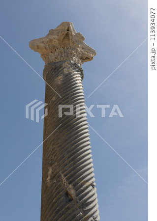 Ancient Corinthian Column Skyward. Close-up of a Corinthian column at the Kourion archaeological site, Cyprus, 113934077