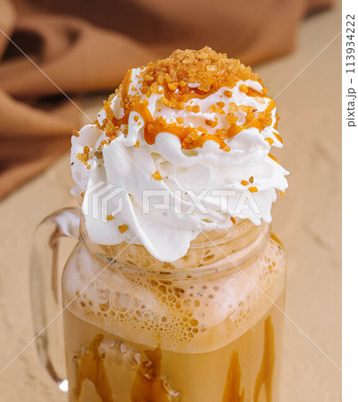 Caramel iced latte with whipped cream and syrup Caramel iced latte with whipped cream and syrup 113934222