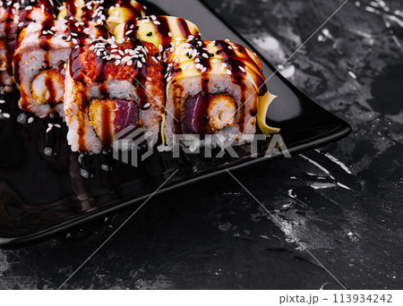 Canada roll with eel on black plate Canada roll with eel on black plate 113934242