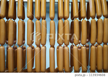 Production of meat sausages. Meat factory and industry. 113934608