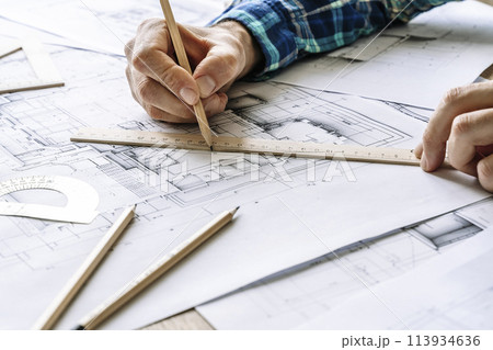 Architectural engineering design plan drawing on the table. Architect's work on table in studio. Construction design and plan 113934636