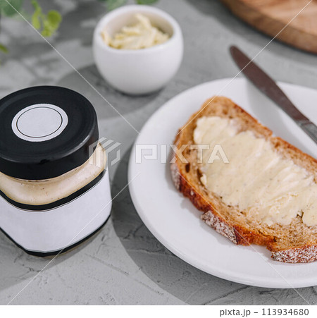 Slice of bread with butter top view 113934680