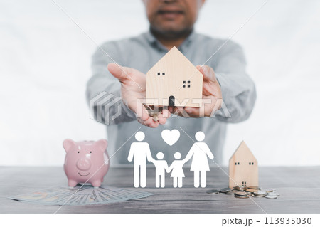 businessman holding simulated wooden house and a key. icon family on table, donation, saving, charity, family finance plan concept, fundraising, superannuation, investment, financial crisis concept. businessman holding simulated wooden house and a key. icon family on table, donation, saving, charity, family finance plan concept, fundraising, superannuation, investment, financial crisis concept. 113935030