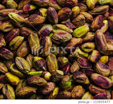 Pistachio nuts background close up Pistachio nuts background close up 113935477