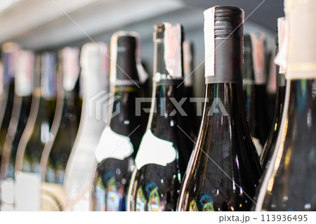 Bottles of wine are placed on a shelf in a department store. Drink concept for parties, weddings, birthdays, Valentine's Day. selective focus, Close up, copy space Bottles of wine are placed on a shelf in a department store. Drink concept for parties, weddings, birthdays, Valentine's Day. selective focus, Close up, copy space 113936495