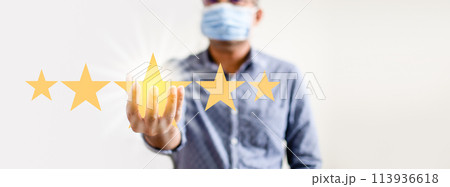 A man is holding up five stars, with one of them being a yellow star 113936618