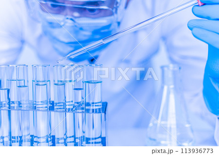 A scientist is working with a series of test tubes A scientist is working with a series of test tubes 113936773