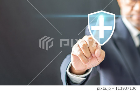 A man is pointing to a blue shield with a white cross on it 113937130