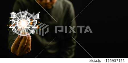 A man is holding a glowing object that says 2012 A man is holding a glowing object that says 2012 113937153