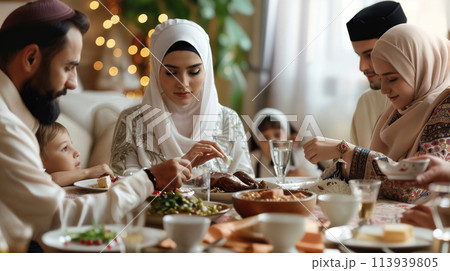 Muslim family gathering around dining table 113939805