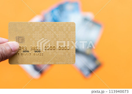 A person is holding a credit card with the number 9933030300000 on it A person is holding a credit card with the number 9933030300000 on it 113940073