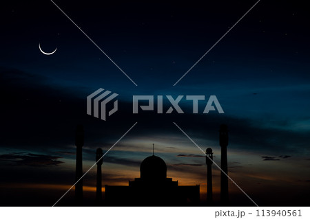 A silhouette of a mosque is shown against a dark sky with a crescent moon A silhouette of a mosque is shown against a dark sky with a crescent moon 113940561