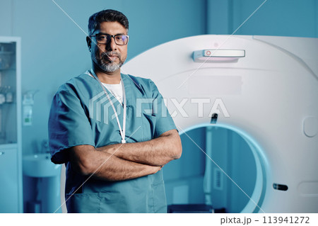 Portrait of professional doctor adjusting MRI scanner settings for next patient 113941272