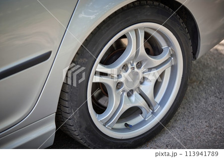 White car with a street background. Modern city car photo 113941789