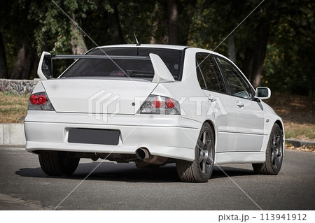 White car on a street background. Modern city sport car with a spoiler wallpaper White car on a street background. Modern city sport car with a spoiler wallpaper 113941912